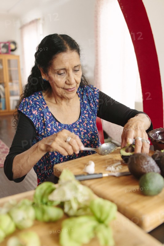 Hispanic woman cooking in kitchen