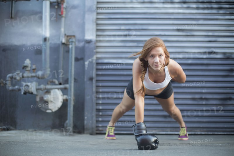 Boxer doing push-ups at warehouse