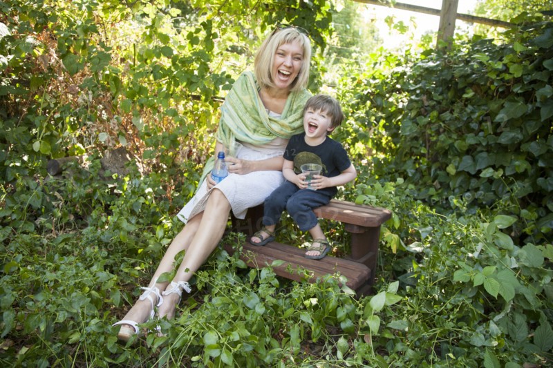 Caucasian grandmother and grandson sitting in garden