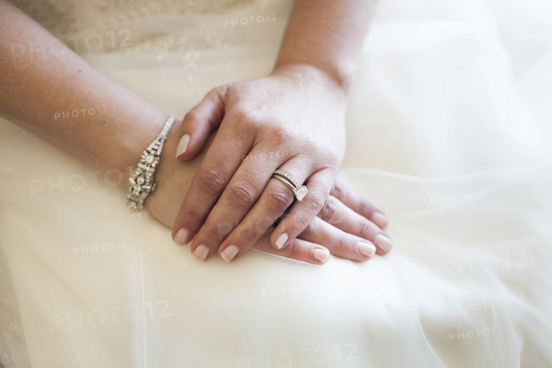 Caucasian bride wearing rings and wedding gown
