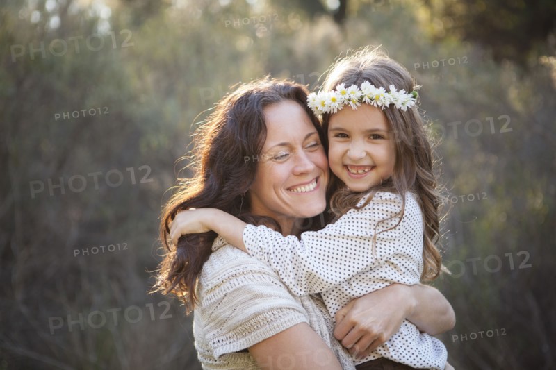 Mother and daughter hugging in park