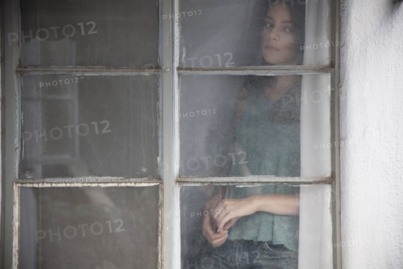 Caucasian woman looking out window
