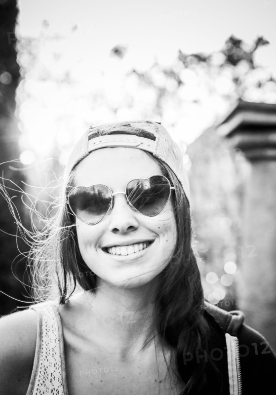 Caucasian teenage girl wearing heart-shaped sunglasses