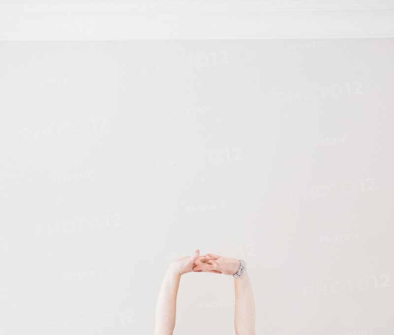 Close up of Caucasian woman stretching arms in midair
