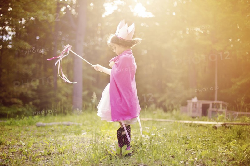 Girl playing princess in backyard