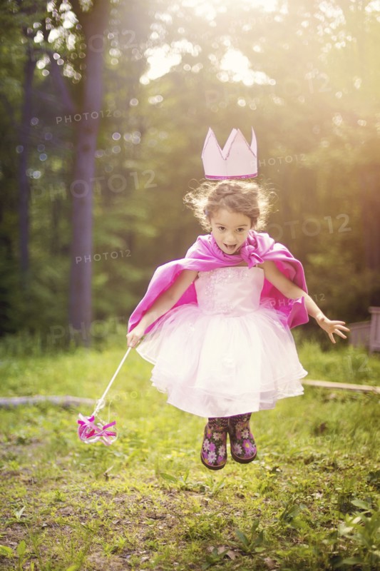 Girl playing princess in backyard