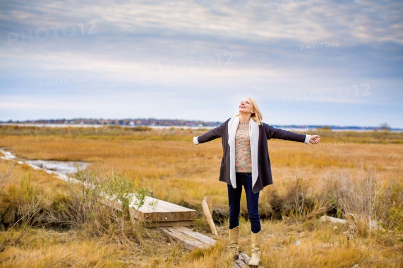 Caucasian woman standing on walkway in rural field