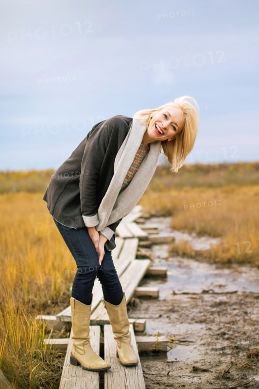 Caucasian woman standing on walkway in rural field