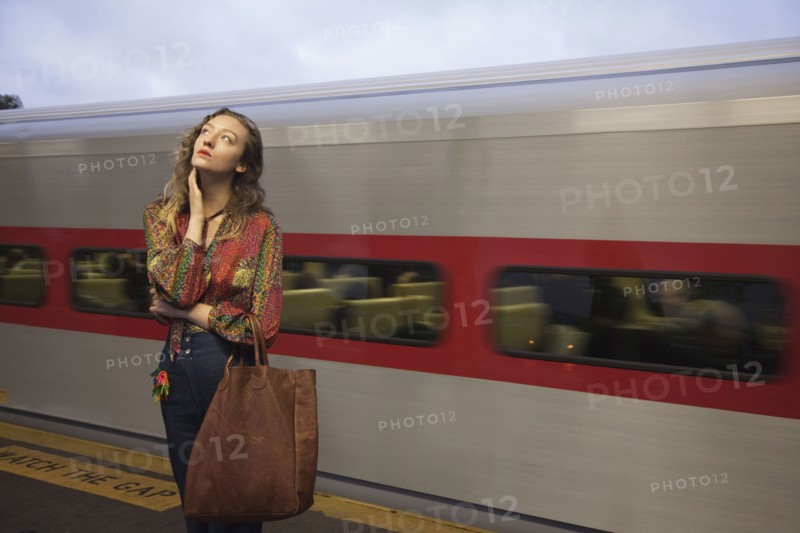 Woman missing passing train in train station