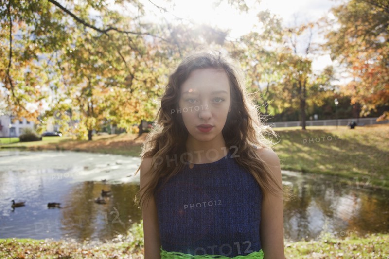Woman standing near duck pond in park