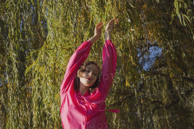 Woman standing under tree in park