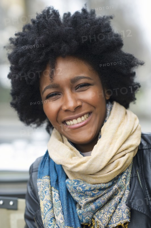 Smiling Black woman wearing scarves