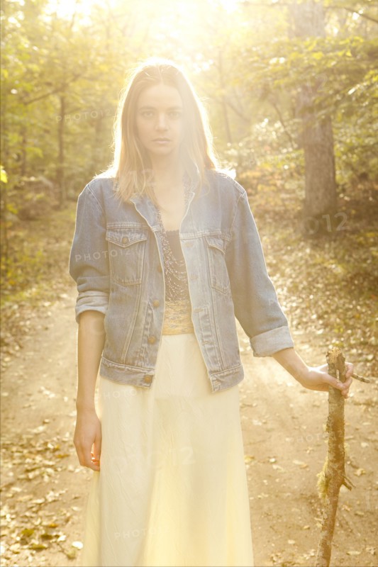 Woman walking on dirt path in forest