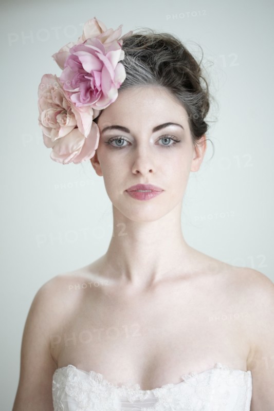 Caucasian bride wearing flower in hair