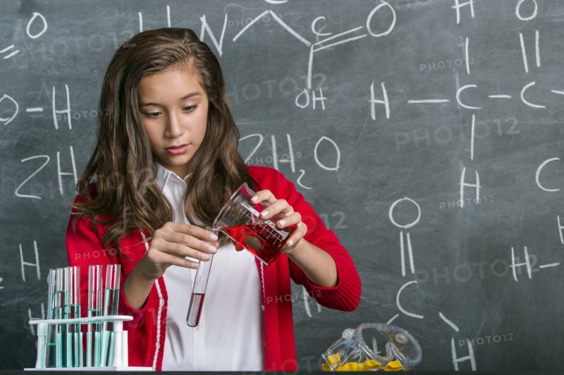 Hispanic student doing experiment in science class