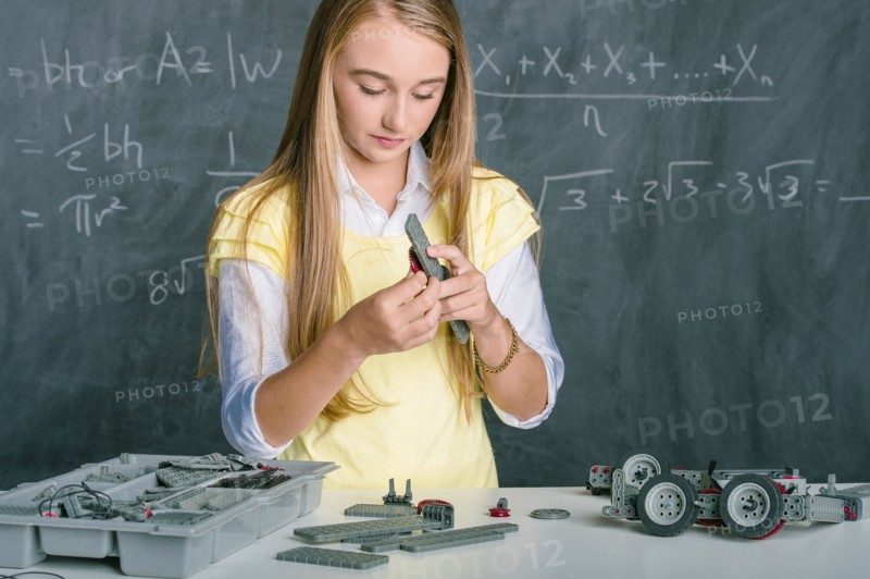 Student building vehicle in science class