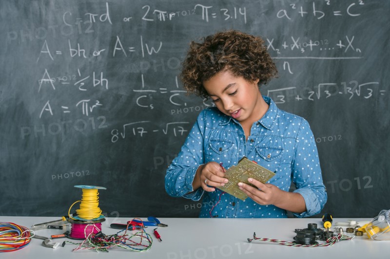 Mixed race student building vehicle in science class