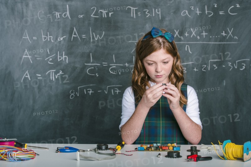 Caucasian student building vehicle in science class