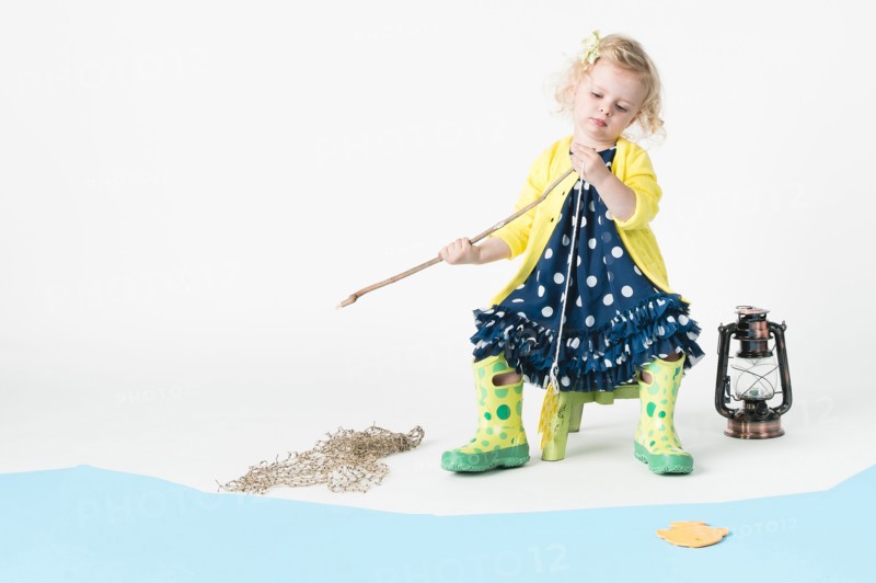 Girl playing fishing with toy fish