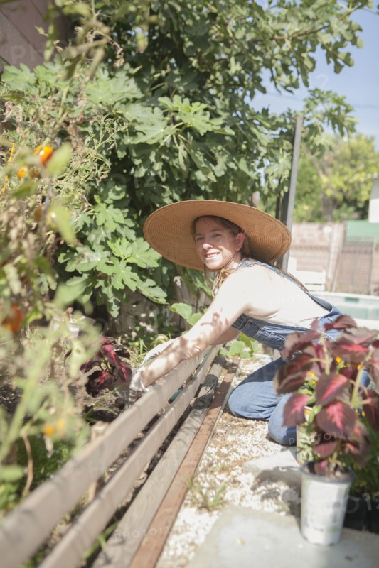 Mixed race farmer working in garden