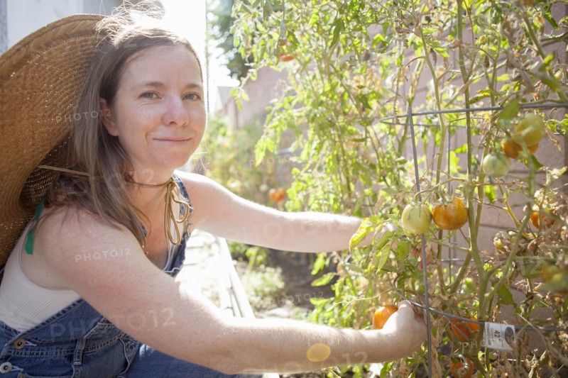 Mixed race farmer working in garden