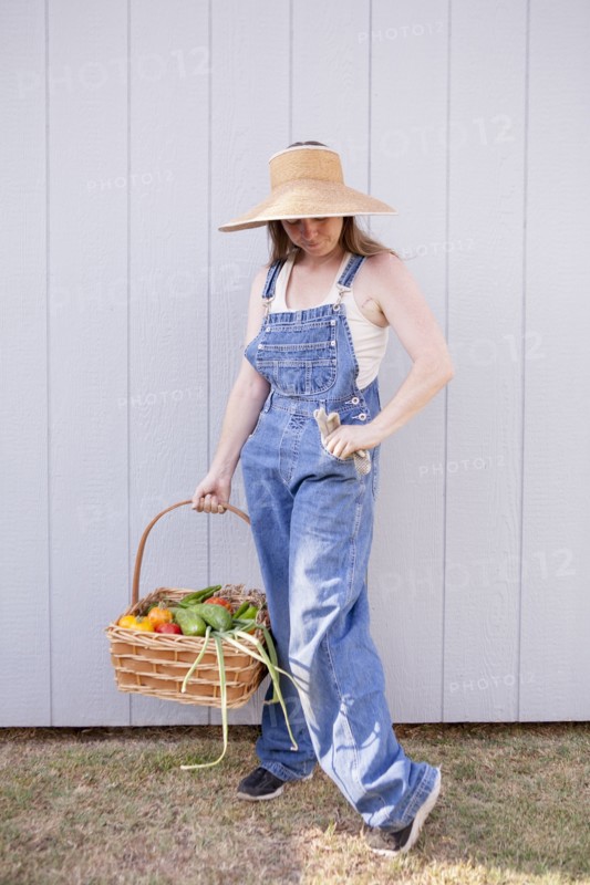 Mixed race farmer holding basket of vegetables