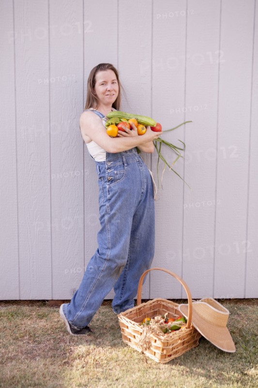 Mixed race farmer with basket of vegetables