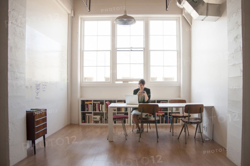 Caucasian businesswoman working on laptop in office