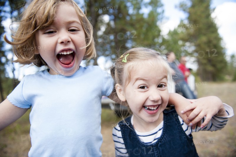 Close up of Caucasian sisters hugging outdoors