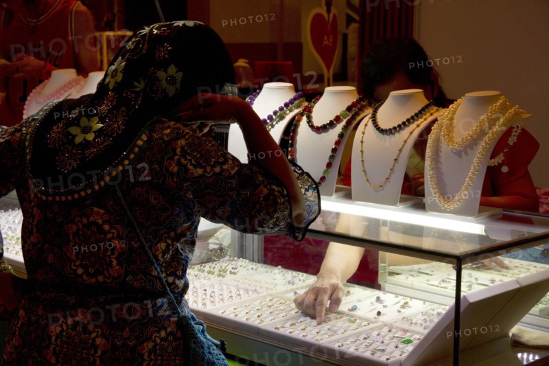Woman shopping for jewelry in store