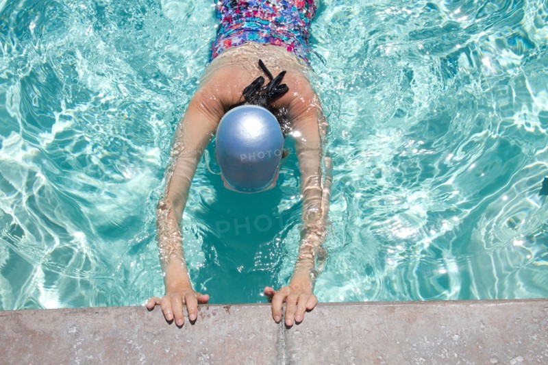 High angle view of Caucasian woman swimming in pool