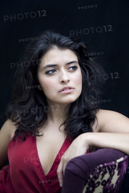 Mixed race woman leaning on armchair