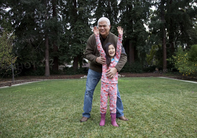Father and daughter playing in backyard