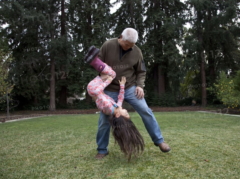 Father and daughter playing in backyard