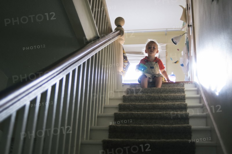 Boy playing at top of staircase