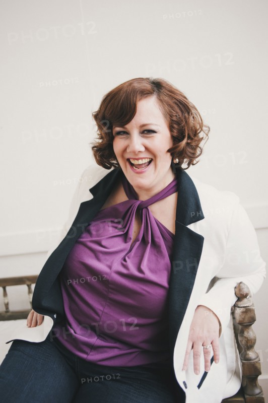 Woman laughing on wooden bench