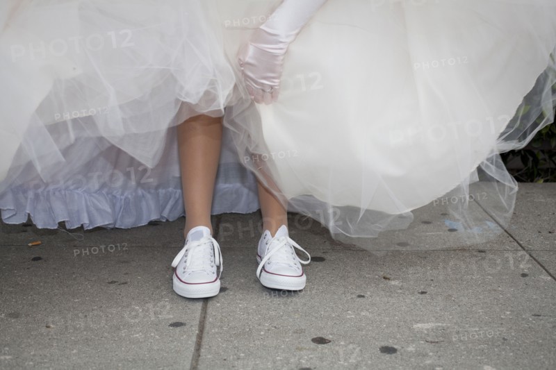 Teenage girl wearing sneakers under quinceanera dress