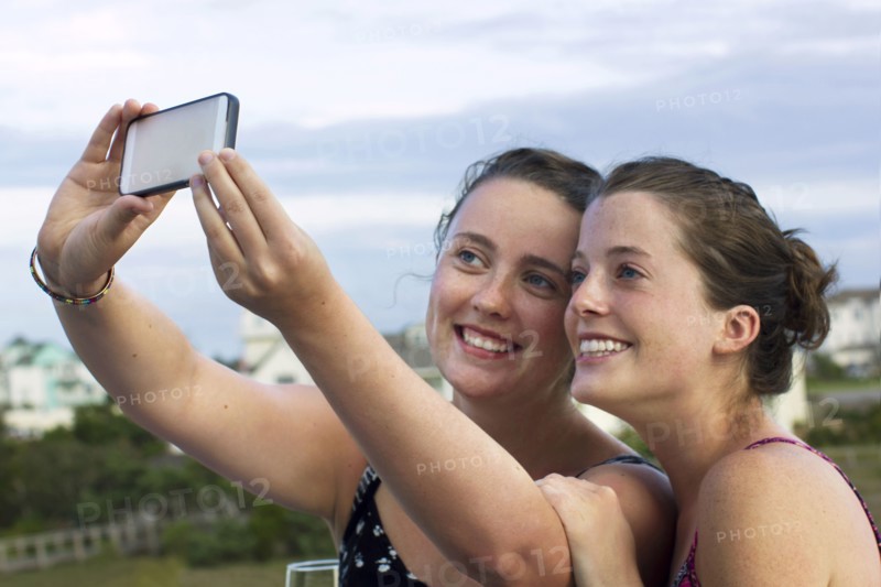 Caucasian women taking selfie with cell phone