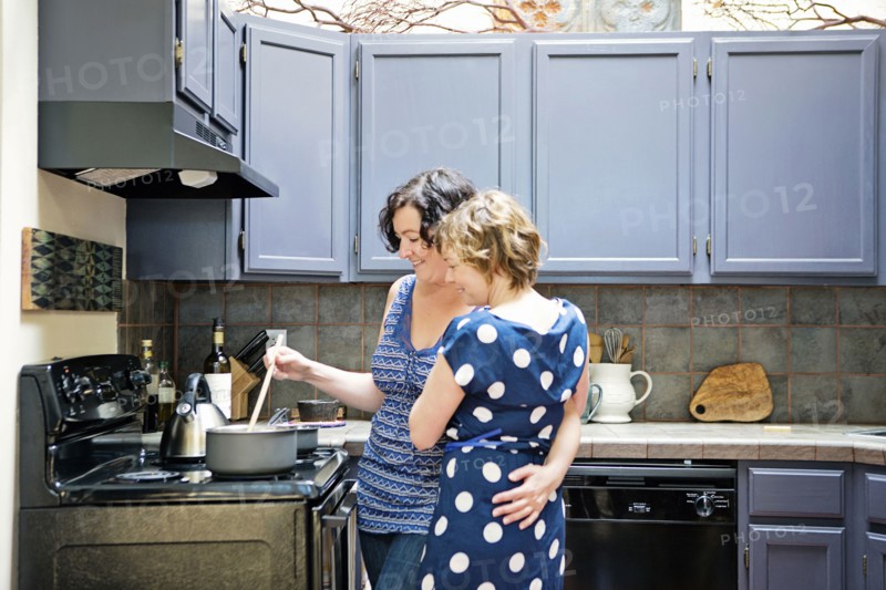 Lesbian couple cooking in kitchen