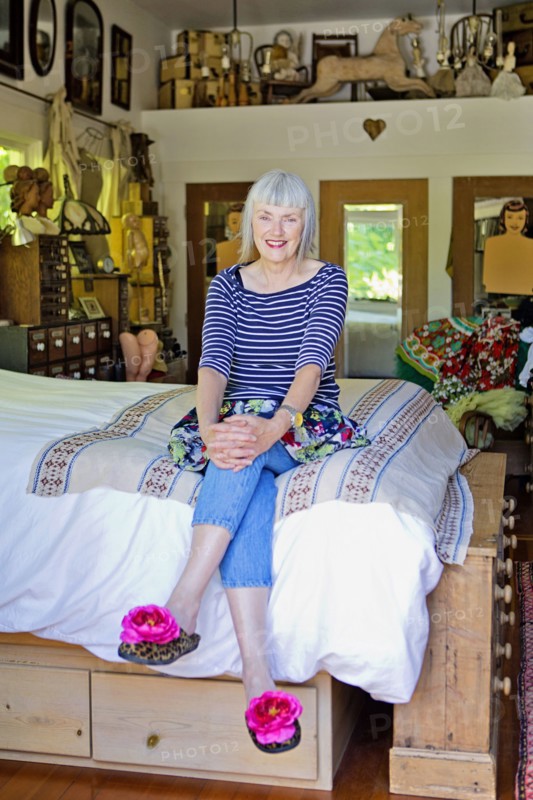 Older Caucasian woman sitting on bed