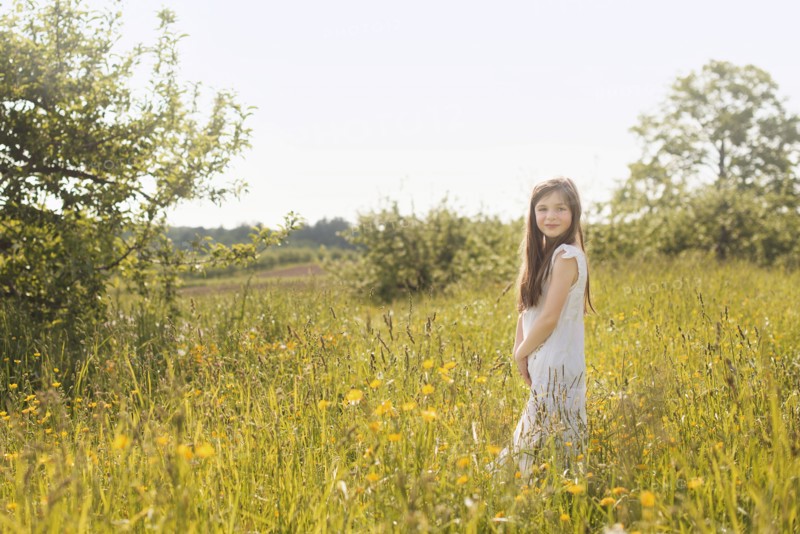 Caucasian girl standing in rural field