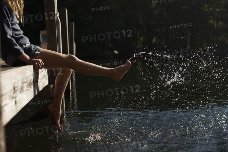 Girl splashing water in lake