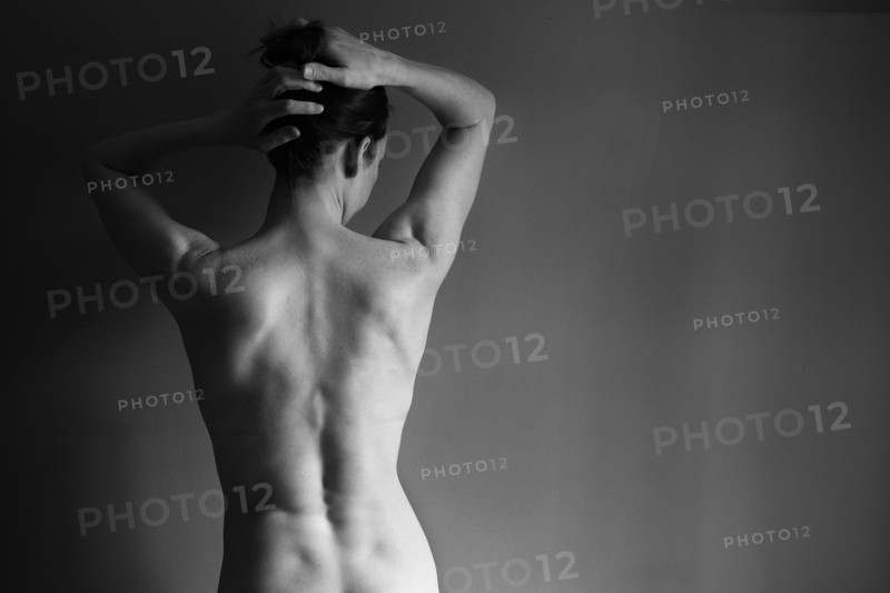 Muscular back of nude Caucasian woman