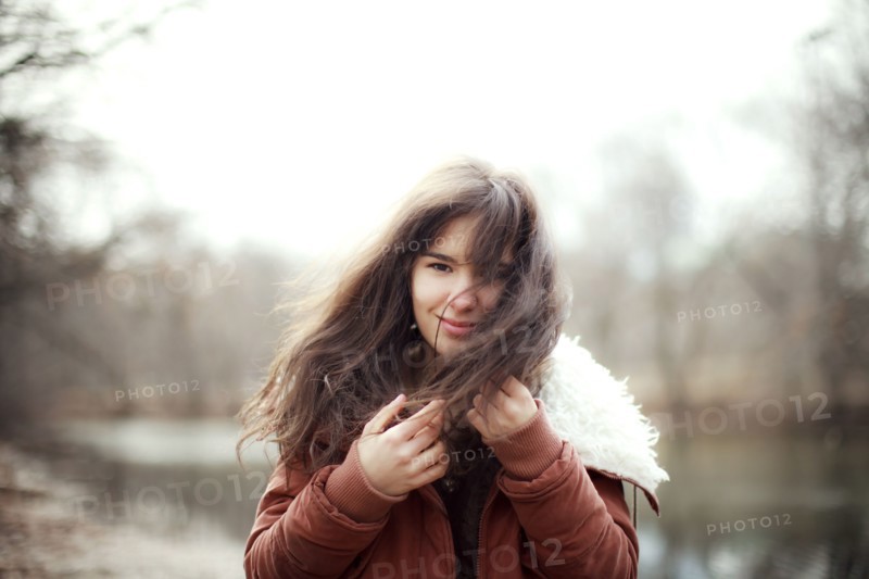 Caucasian woman wearing furry coat outdoors