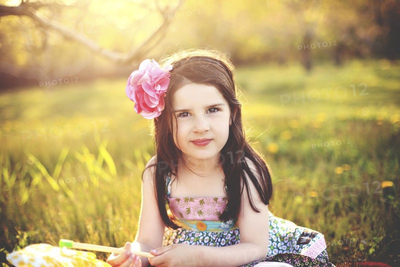 Girl playing with pinwheel in rural field
