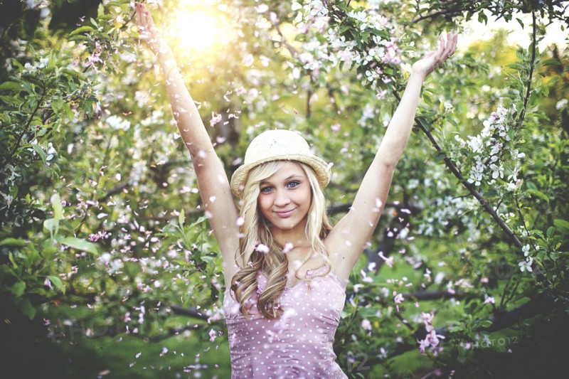 Woman standing in flowering trees