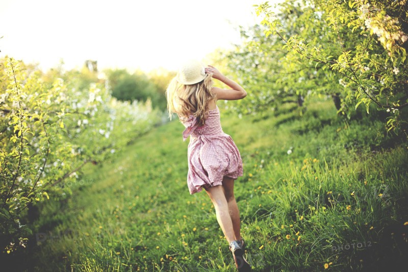 Woman walking in rural orchard