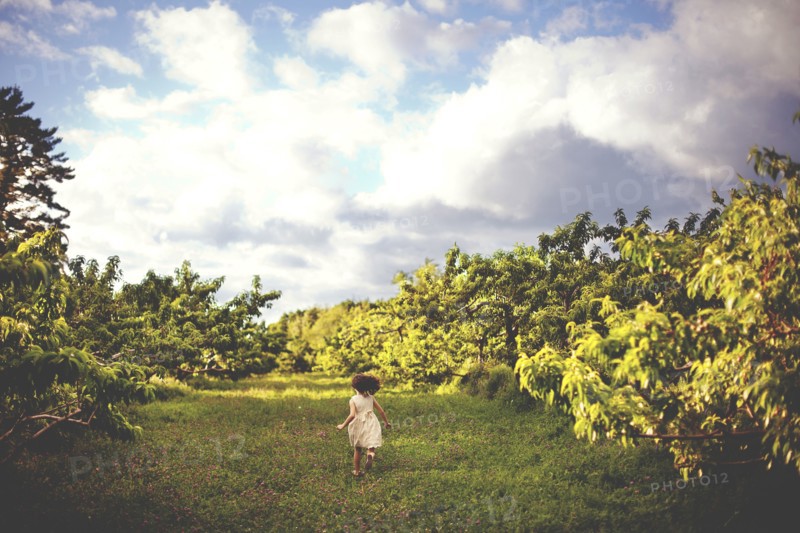 Girl running in rural field