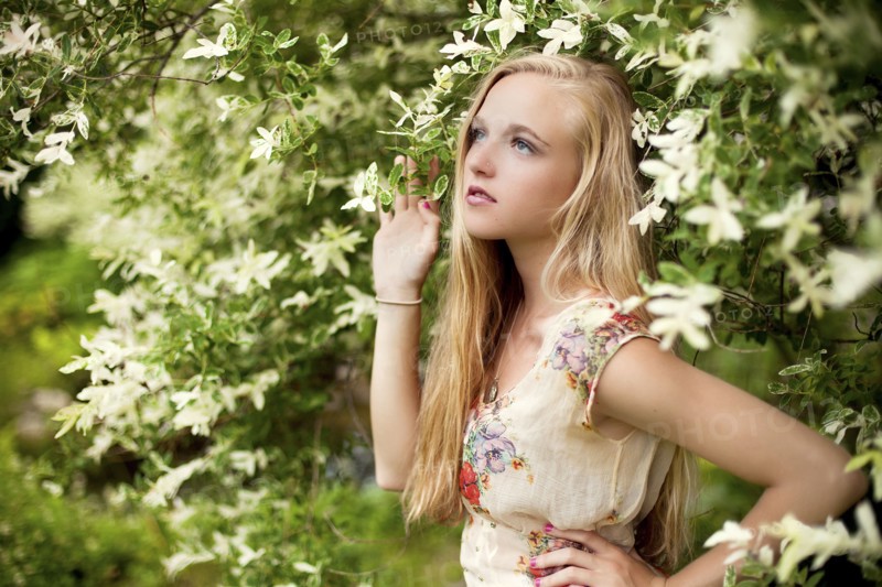 Woman standing under flowering tree