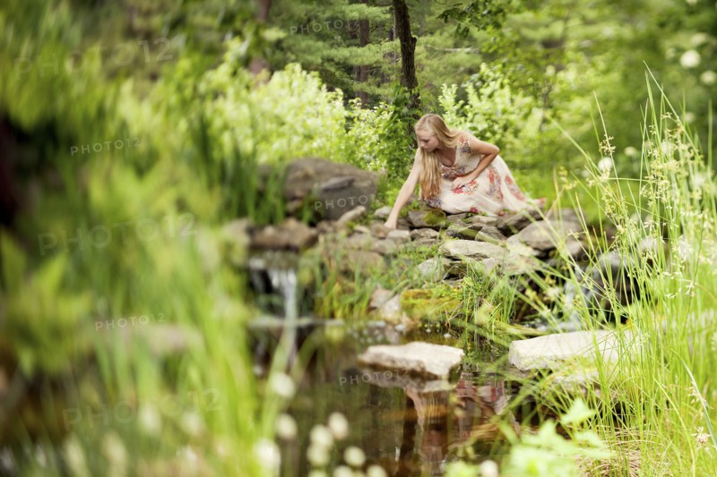 Woman exploring rural pond